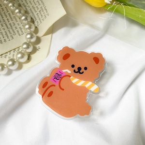 Macro shot of cute acrylic bear phone grip holding a soda can on soft aesthetic background
