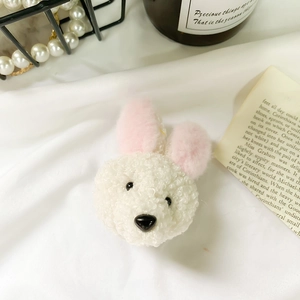 Close-up of cute plush bunny phone grip made of soft cream-colored teddy fleece texture