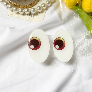 Close-up of cute cartoon large eyes phone socket on aesthetic white fabric background