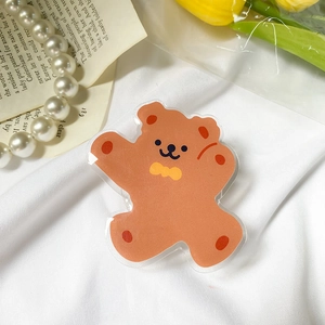 Detail of cute brown bear phone grip with acrylic finish and bow tie decoration