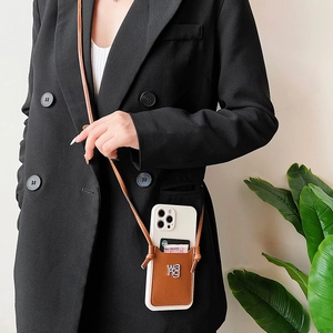 Detail of crossbody iPhone case featuring a brown leather wallet and adjustable strap