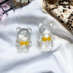 Close-up of transparent resin bear phone grips with cute yellow cherry embellishments
