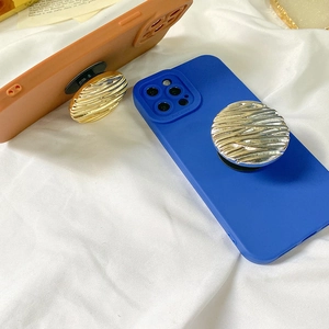 Detail of round metallic water ripple phone sockets on colorful matte silicone cases