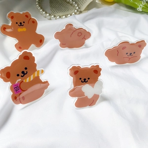Cute cartoon bear acrylic phone grip sockets with heart and soda designs on white fabric