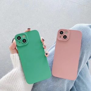 Detailed view of pink and green silicone cases with Pro Camera lens protection for iPhone