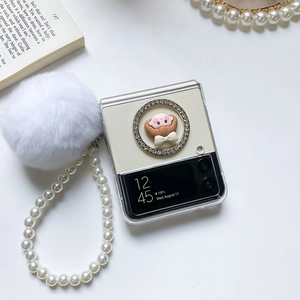 Close-up of clear Samsung Z Flip case featuring white pompom and large pearl handle strap