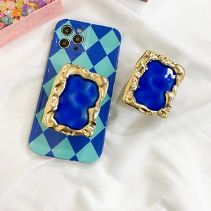 Blue checkerboard phone case with vintage gold-trimmed resin pop socket grip
