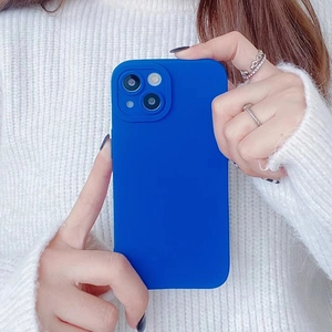 Detail of Klein Blue silicone phone case with raised camera protection on white sweater