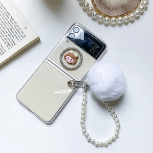Detail of Galaxy Z Flip case with pearl lanyard, fur ball charm, and girl pattern design