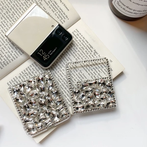 Close-up of sparkling rhinestone phone case for Galaxy Z Flip on a vintage book