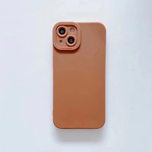 Close-up of matte orange-brown silicone phone case with raised Pro Camera protection frame