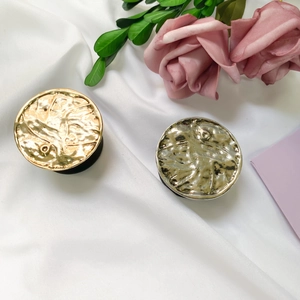 Macro view of metallic ripple texture phone grips in gold and silver plating