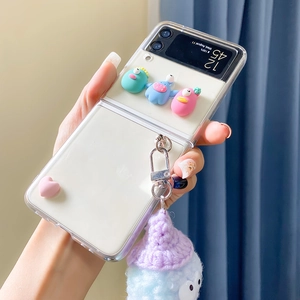 Detail of clear folding phone case with plush monster charm for Samsung Z Flip