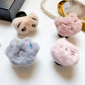 Detail view of plush animal phone grips featuring cute bear and cat embroidery designs