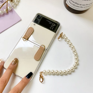 Detail view of transparent Z Flip case with brown leather loops and pearl strap