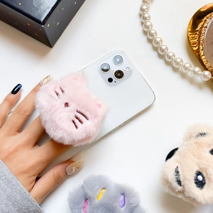 Close-up of pink plush cat head phone socket with soft faux fur and embroidery details