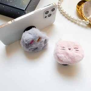 Detail of plush cat phone socket with soft fur and cute embroidery in pink and grey