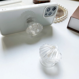 Elegant shell-shaped expandable phone socket stand with realistic resin texture and pearl