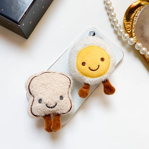 Close-up of cute plush toast and egg phone sockets with soft fiber textures