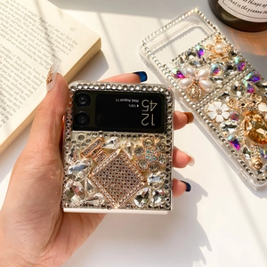 Detail of luxury rhinestone bear and floral pearl decor on Galaxy Z Flip case