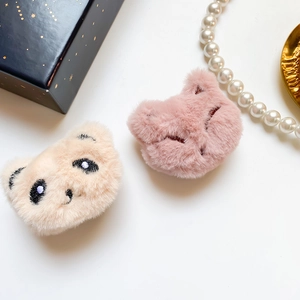 Close-up of plush panda and cat phone grips with soft texture and cute embroidery