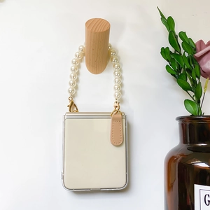 Detail of Galaxy Z Flip case featuring large pearl chain strap and leather trim