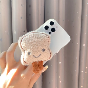 Close-up of cute plush toast phone grip with smile embroidery on white smartphone