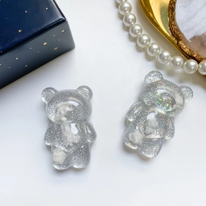 Macro shot of glittery resin bear phone grip with cloud filling and crystal accents