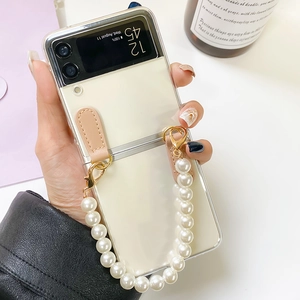 Detail of white pearl wrist strap on clear phone case for Samsung Z Flip foldable series