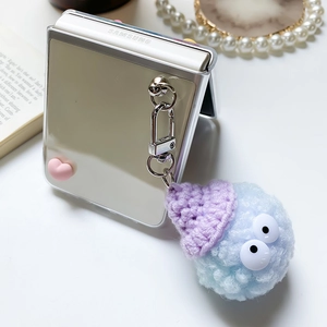 Mirror Samsung Z Flip case featuring blue plush monster charm and pink 3D hearts