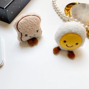 Detailed plush toast and fried egg characters featuring soft texture and cute embroidery