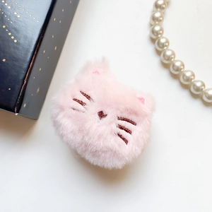 Close-up of cute pink plush cat phone grip with embroidery beside a gift box