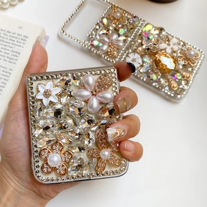 Detailed view of Samsung Z Flip case with luxury rhinestones, pearls and floral accents