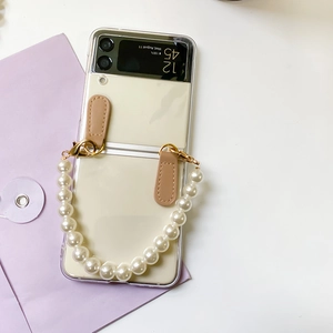 Close-up of pearl chain strap with gold clasp on transparent Samsung Z Flip case