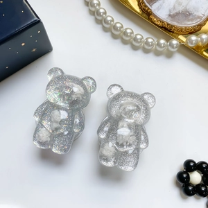 Close-up of glitter bear phone grips with resin texture and sparkling silver finish