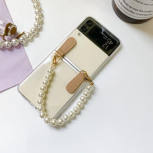 Detail of transparent Galaxy Z Flip case with elegant pearl strap and gold hardware