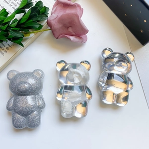 Detailed view of three cute 3D bear-shaped collapsible phone grips in various textures