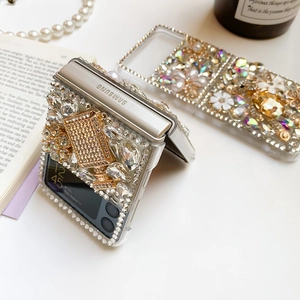 Detail of luxury Samsung Z Flip case with handmade rhinestones, pearls, and a gold perfume bottle
