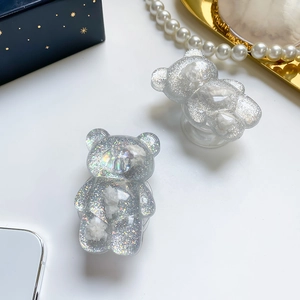 Macro view of two cute bear phone grip holders with silver glitter resin and white accents