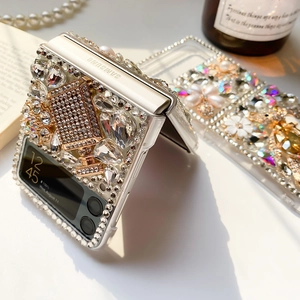 Close-up of luxury phone case with pearls, rhinestones, and floral details for Samsung Z Flip