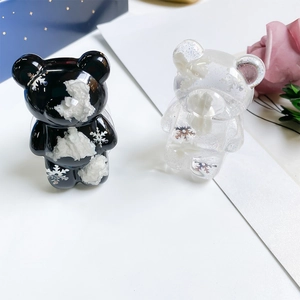 Close-up of bear-shaped phone grips with silver snowflakes and white clouds inside