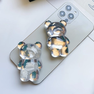 Close-up of clear resin bear phone socket stand showing glossy 3D texture and grip