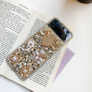 Detail of luxury Samsung Z Flip case featuring rhinestone bear and pearl flower charms