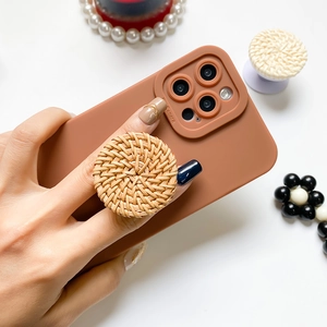 Minimalist terracotta phone case with a natural round rattan air cushion stand holder