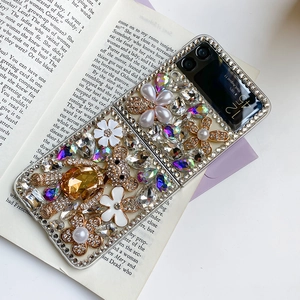 Detailed view of the luxury Z Flip case with a sparkling rhinestone bear and floral accents