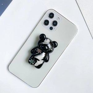 Detail shot of a black bear griptok with silver snowflake patterns on a white phone