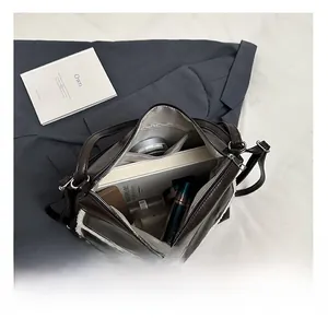Top view of the spacious inner compartment showing books and cosmetics in a tote bag