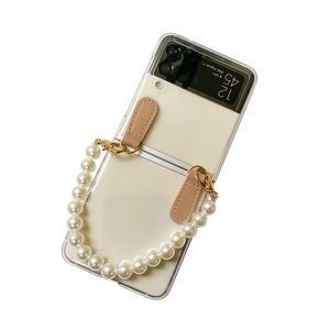 Transparent Samsung Z Flip case with large pearl wrist strap and beige leather hook