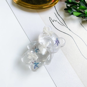 Detail of transparent bear phone grip with blue gradient snowflakes and glitter