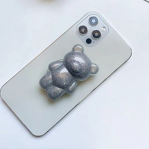 Glittery bear phone socket grip in translucent grey on white smartphone back